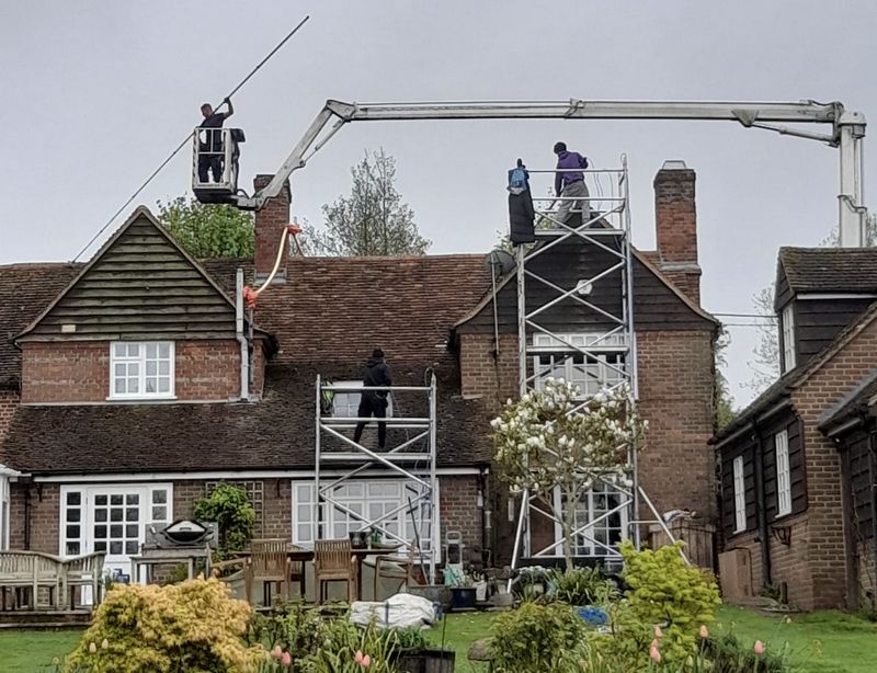 The Moss Cleaners using cherry picker and scaffolding to clean roof safely and professionally in Ludgershall, Wiltshire